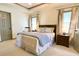 Spacious main bedroom features a comfortable bed, sitting area, and access to the ensuite bathroom at 1835 Penrose Ct, Powder Springs, GA 30127