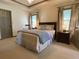 Spacious main bedroom features a comfortable bed, sitting area, and access to the ensuite bathroom at 1835 Penrose Ct, Powder Springs, GA 30127