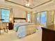 Inviting main bedroom features a tray ceiling, a comfortable bed, and ensuite bathroom access at 1835 Penrose Ct, Powder Springs, GA 30127