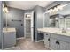 Bathroom featuring dual vanities, tile flooring, decorative lighting, and doorway to bedroom at 2023 Reserve Pkwy, Mcdonough, GA 30253