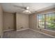 Bedroom with plush carpeting and a window overlooking green outdoor scenery, neutral walls at 2023 Reserve Pkwy, Mcdonough, GA 30253