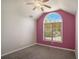 Bedroom with vaulted ceiling, large window overlooking green outdoor scenery, and neutral carpet at 2023 Reserve Pkwy, Mcdonough, GA 30253