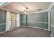 Formal dining room with chair rail, carpet, modern light fixture, and large window at 2023 Reserve Pkwy, Mcdonough, GA 30253