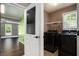 Convenient laundry room with black washer and dryer units, accessible from the basement at 2023 Reserve Pkwy, Mcdonough, GA 30253