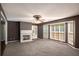 Cozy living room featuring a marble fireplace, and large windows for ample natural light at 2023 Reserve Pkwy, Mcdonough, GA 30253