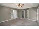 Spacious main bedroom with neutral walls, plush carpeting, and multiple closets and door entrances at 2023 Reserve Pkwy, Mcdonough, GA 30253