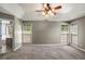 Spacious main bedroom featuring tray ceilings, two windows, neutral walls, and plush carpeting at 2023 Reserve Pkwy, Mcdonough, GA 30253