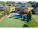 Aerial view of the home's backyard featuring a swimming pool with an adjacent manicured lawn and lush landscaping at 2199 Tayside Nw Xing, Kennesaw, GA 30152