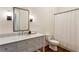 Stylish bathroom features a gray vanity with marble countertop, mirror, and shower at 2199 Tayside Nw Xing, Kennesaw, GA 30152