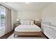 Cozy bedroom with hardwood floors, neutral colors, and a crib offering a serene and inviting atmosphere at 2199 Tayside Nw Xing, Kennesaw, GA 30152