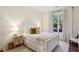 Cozy bedroom with neutral tones, a comfortable bed, and a view of the yard at 2199 Tayside Nw Xing, Kennesaw, GA 30152