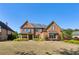 Beautiful brick home with a manicured front lawn and colorful flower beds under a clear blue sky at 2199 Tayside Nw Xing, Kennesaw, GA 30152