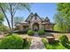 Charming home featuring stone accents, arched entry, and well-manicured landscaping at 2199 Tayside Nw Xing, Kennesaw, GA 30152