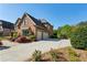 Side view of a brick home showcasing a two-car garage, long driveway, and a basketball hoop at 2199 Tayside Nw Xing, Kennesaw, GA 30152