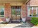 Elegant double front doors framed by brickwork, with decorative planters adding to the welcoming entrance at 2199 Tayside Nw Xing, Kennesaw, GA 30152