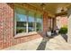 Charming front porch featuring brick detail and stone flooring, complemented by a well-lit and inviting entrance at 2199 Tayside Nw Xing, Kennesaw, GA 30152