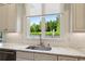 Bright kitchen featuring a sink with a large window overlooking the landscaped backyard at 2199 Tayside Nw Xing, Kennesaw, GA 30152