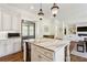 Open-concept kitchen featuring a center island with marble countertop and view to living area at 2199 Tayside Nw Xing, Kennesaw, GA 30152