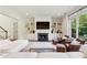 Comfortable living room with fireplace, built-in shelving, leather chairs, and large bright windows at 2199 Tayside Nw Xing, Kennesaw, GA 30152