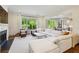 Bright and airy living room featuring a fireplace, large windows, and a comfortable white sectional sofa at 2199 Tayside Nw Xing, Kennesaw, GA 30152