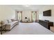 Spacious living room with a large sofa, TV, and lots of natural light that creates a relaxed atmosphere at 2199 Tayside Nw Xing, Kennesaw, GA 30152