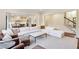 Spacious living room with a large white sectional, brown accent chairs, and view to kitchen area at 2199 Tayside Nw Xing, Kennesaw, GA 30152