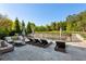Relaxing outdoor patio area with lounge chairs, umbrellas, and view of the lush backyard at 2199 Tayside Nw Xing, Kennesaw, GA 30152