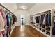 Spacious walk-in closet with custom shelving and hardwood floors, providing ample storage and organization at 2199 Tayside Nw Xing, Kennesaw, GA 30152