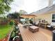 Backyard wooden deck with hot tub, patio furniture, umbrella, and a neatly kept lawn at 4025 Mcdowell Dr, Acworth, GA 30101