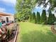 Well-maintained backyard with a wooden deck, garden, and beautifully manicured lawn at 4025 Mcdowell Dr, Acworth, GA 30101