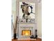 Close-up view of fireplace with a brick surround and mantel, adorned with artwork and decorative items at 4025 Mcdowell Dr, Acworth, GA 30101
