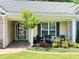 Charming front porch entrance adorned with brick accents, tiled flooring, and cozy seating at 4025 Mcdowell Dr, Acworth, GA 30101