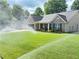 Exterior of charming home with lush lawn, sprinkler system, and inviting front porch seating at 4025 Mcdowell Dr, Acworth, GA 30101