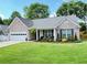Charming single-story home features a brick facade, well-manicured lawn, and attached garage at 4025 Mcdowell Dr, Acworth, GA 30101