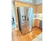 Kitchen area featuring stainless steel refrigerator, wood cabinets, and granite counter tops at 4025 Mcdowell Dr, Acworth, GA 30101
