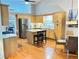 Bright kitchen features stainless steel appliances, wood cabinets, an island, and hardwood flooring at 4025 Mcdowell Dr, Acworth, GA 30101