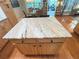 Close-up of kitchen island with granite countertop and wooden cabinets at 4025 Mcdowell Dr, Acworth, GA 30101