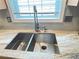 A close up of the stainless steel double bowl kitchen sink with granite countertops at 4025 Mcdowell Dr, Acworth, GA 30101