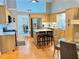 Bright kitchen featuring stainless steel appliances, wood cabinets, an island, and hardwood floors at 4025 Mcdowell Dr, Acworth, GA 30101