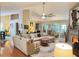 Spacious living room with hardwood floors, a ceiling fan, fireplace, and large sectional sofa at 4025 Mcdowell Dr, Acworth, GA 30101