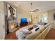 Cozy living room featuring a fireplace, ceiling fan, and a comfortable sectional sofa at 4025 Mcdowell Dr, Acworth, GA 30101