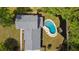 Aerial view showcasing the pool and the home's roofline and landscaping at 4841 Village North Ct, Atlanta, GA 30338