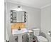Charming bathroom with decorative mirror and pedestal sink at 4841 Village North Ct, Atlanta, GA 30338