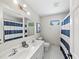 A well lit bathroom with a double sink, vanity, and shower at 4841 Village North Ct, Atlanta, GA 30338
