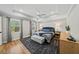 Comfortable main bedroom featuring tray ceiling, ceiling fan, and natural light at 4841 Village North Ct, Atlanta, GA 30338