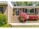 Charming home exterior featuring brick facade and colorful azalea bushes at 4841 Village North Ct, Atlanta, GA 30338