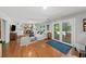 Open living room with a brick fireplace, French doors, and access to the outdoor pool area at 4841 Village North Ct, Atlanta, GA 30338