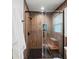 Beautiful shower room with wood-look tiling, a built-in bench, and a black showerhead at 4841 Village North Ct, Atlanta, GA 30338