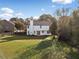 Large, grassy backyard with wooden fence, back view of the two-story home, and patio at 946 Steadman Ter, Marietta, GA 30064