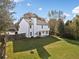 Large, grassy backyard with wooden fence, back view of the two-story home, and patio at 946 Steadman Ter, Marietta, GA 30064